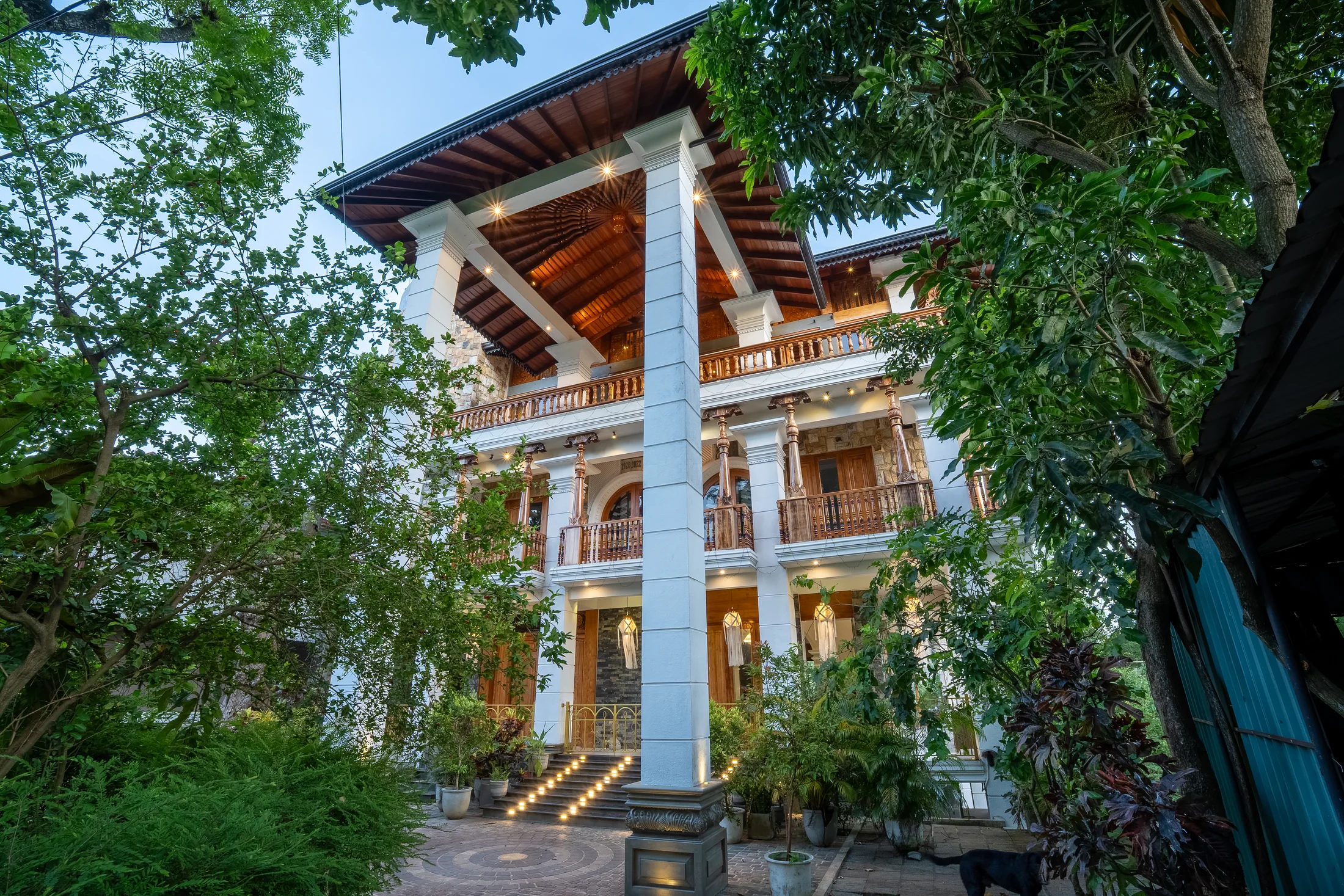 Stone and timber exterior framed by mature trees