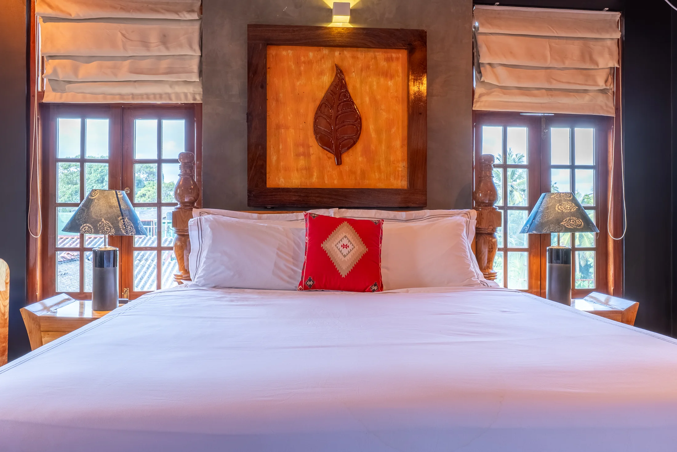 Handcrafted timber bed set against deep charcoal walls