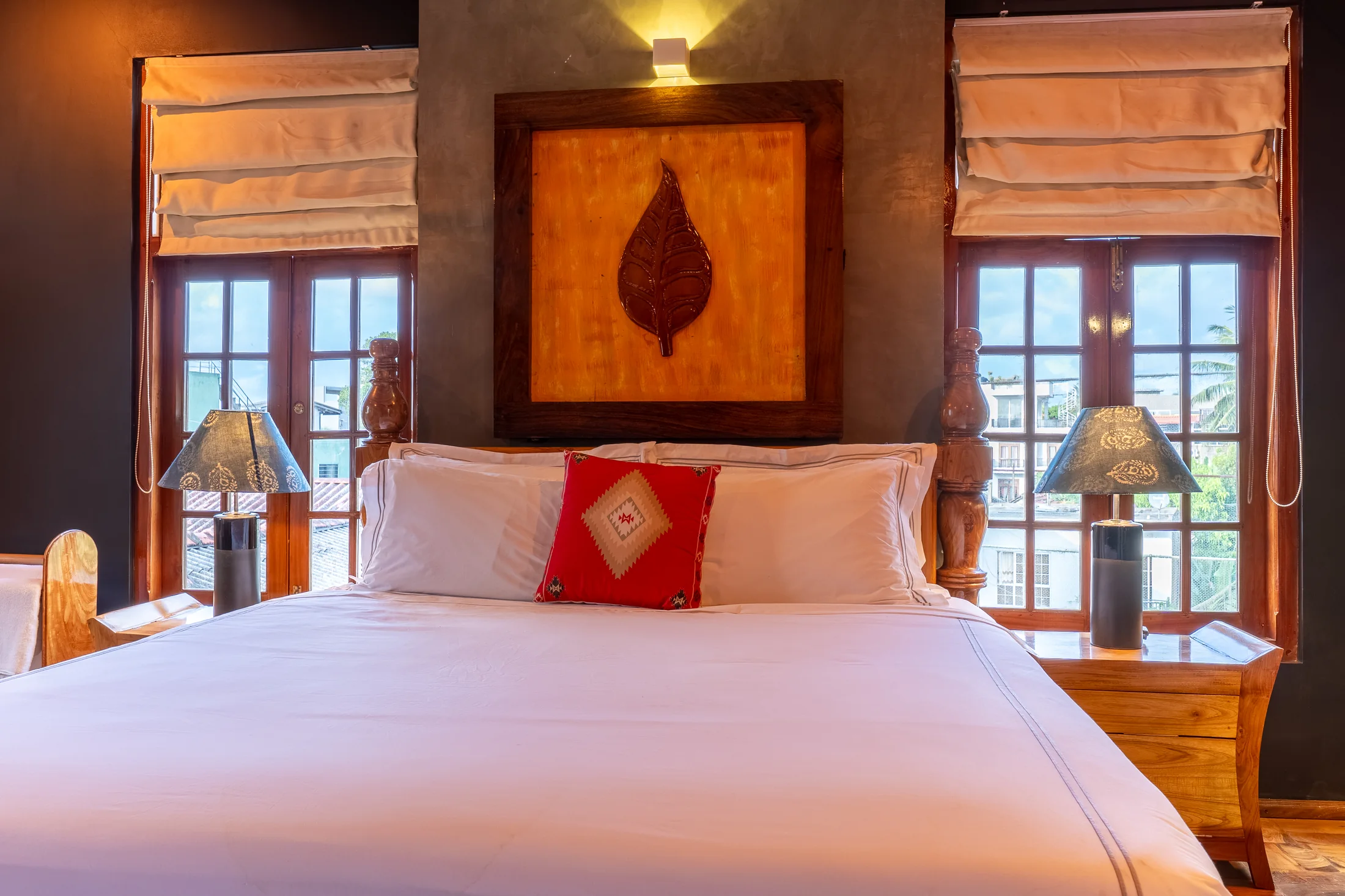 Handcrafted timber bed set against deep charcoal walls