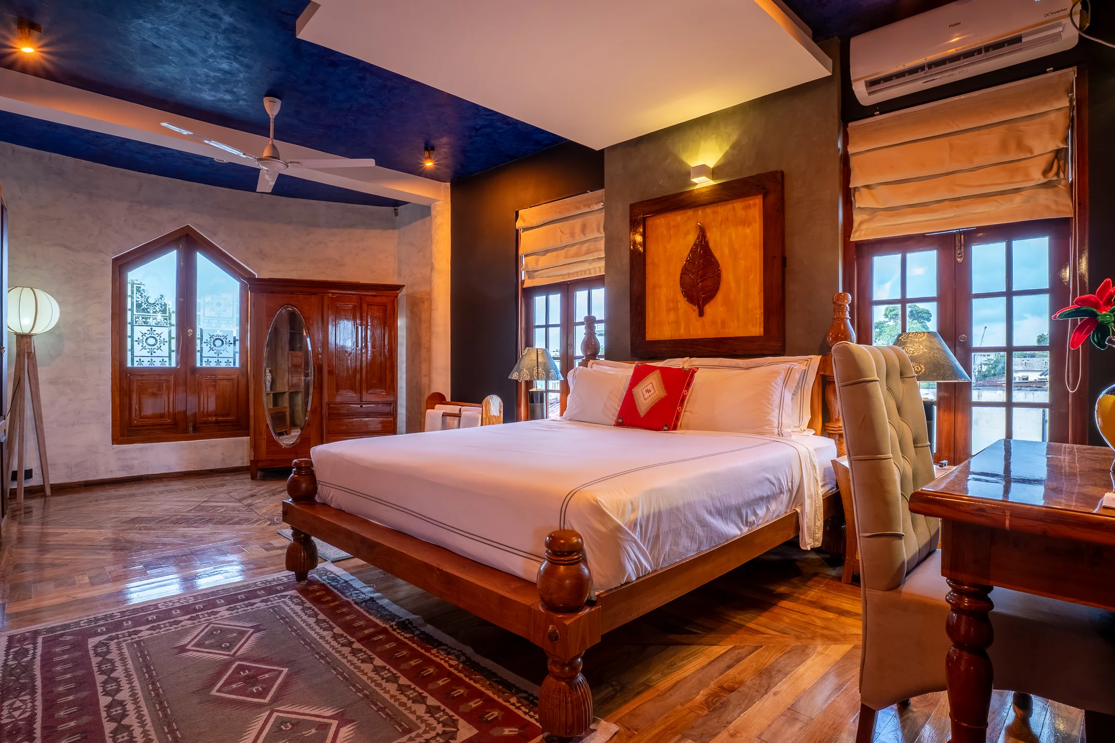 Private bedroom with polished wood floors and garden-facing windows