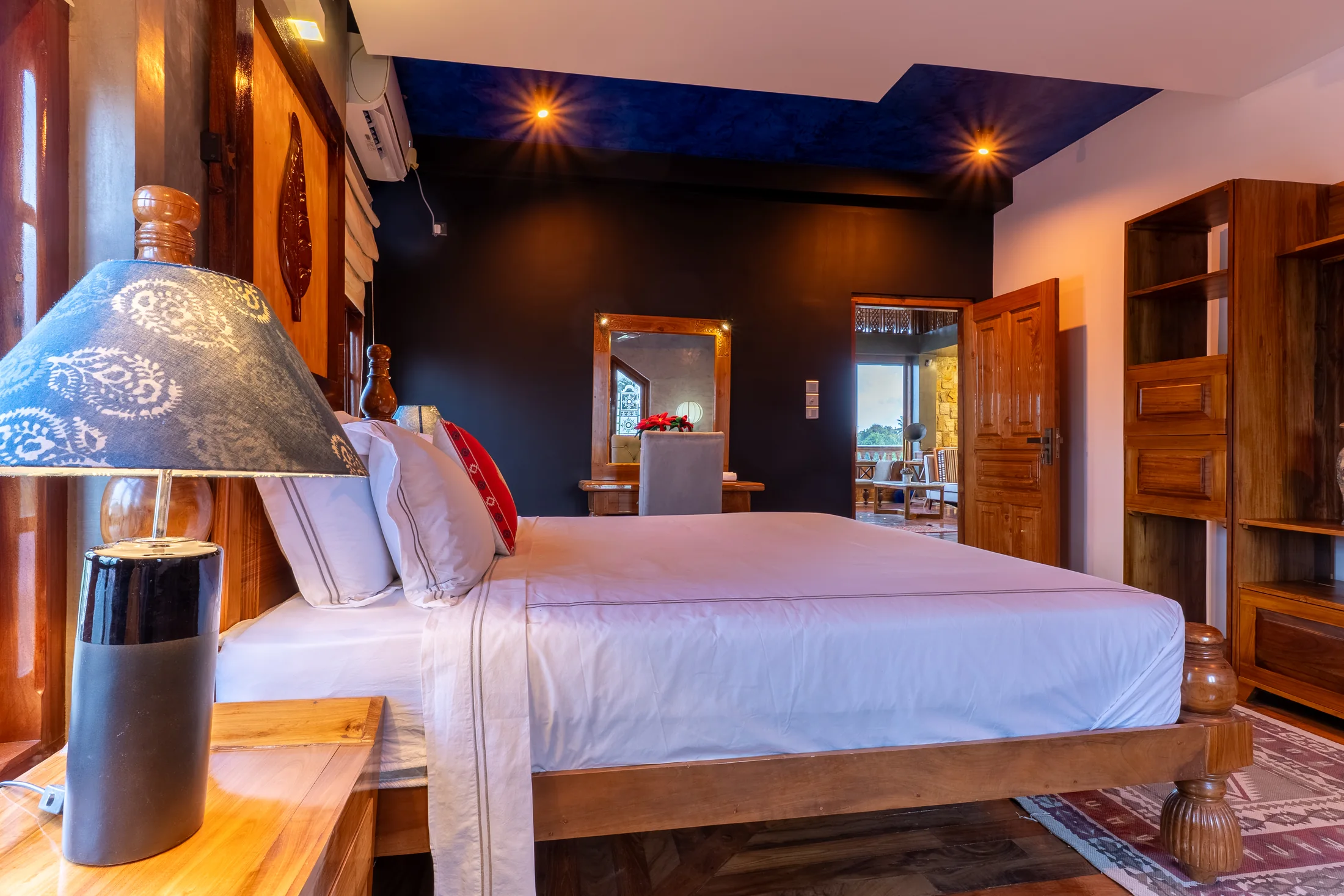 Warm bedroom detail with traditional carved furnishings