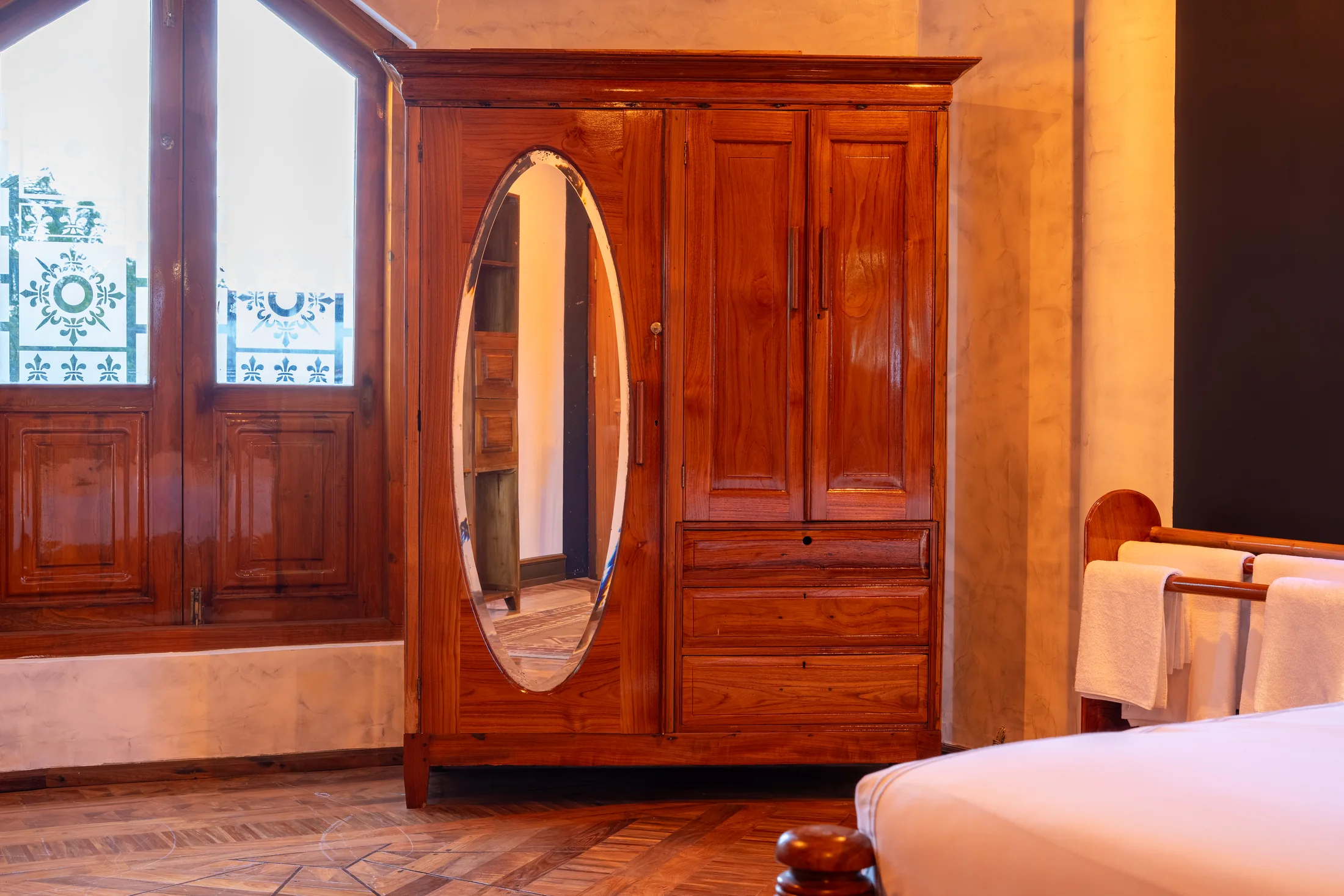 Private bedroom with polished wood floors and garden-facing windows