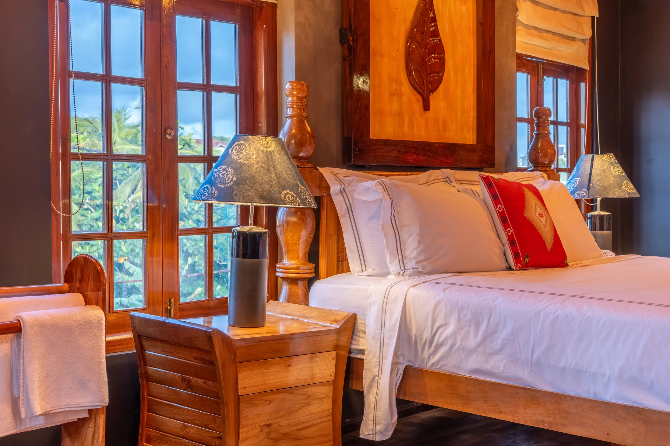 Warm bedroom detail with traditional carved furnishings