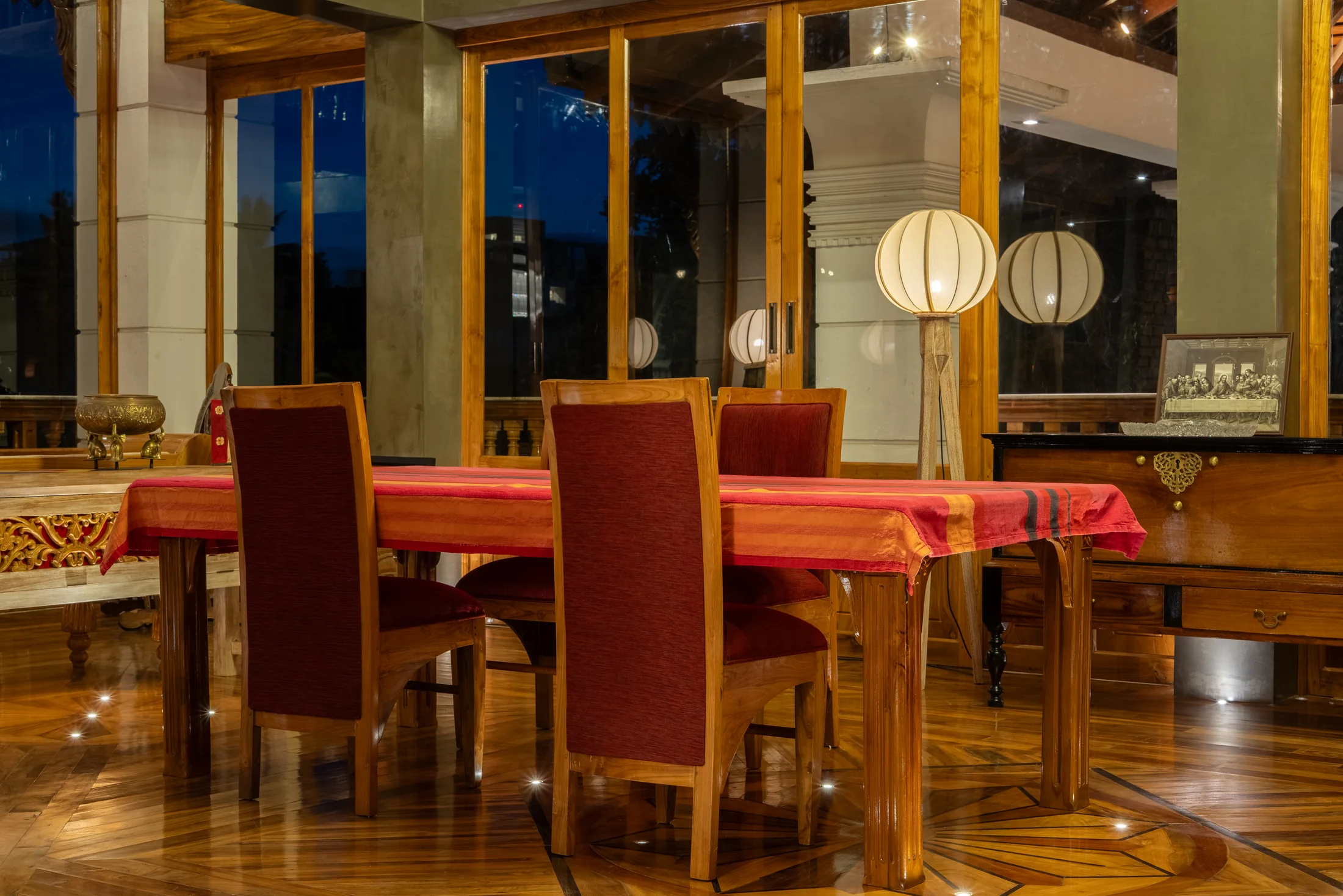 Dining space with panoramic openings and warm evening light