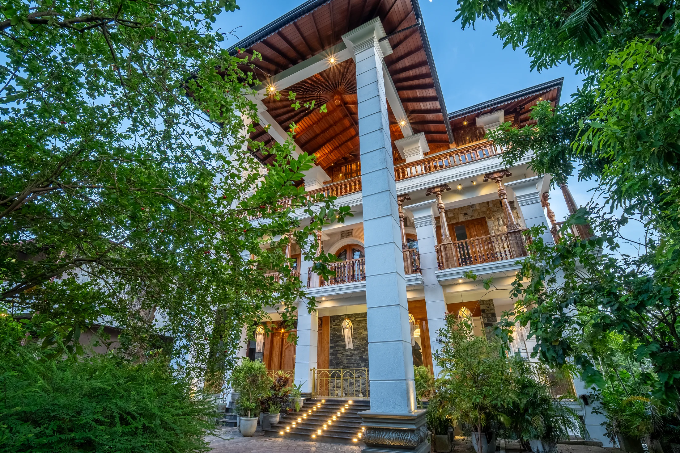 Full view of the residence and its illuminated entrance