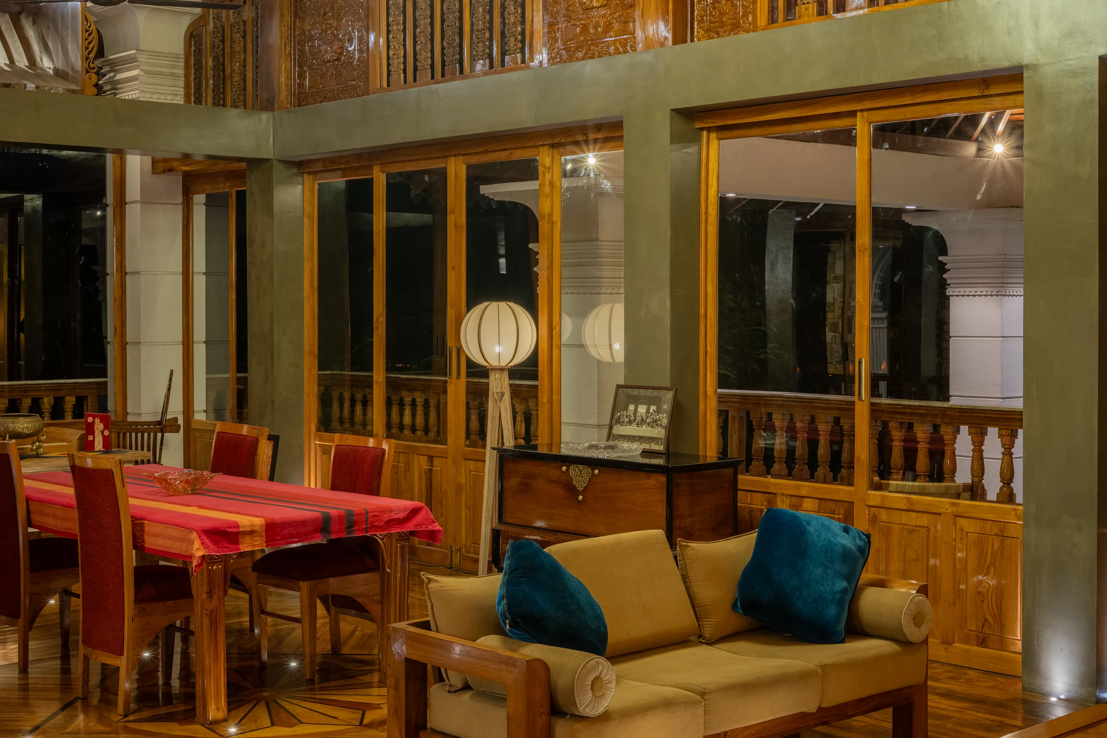 Open-plan living room beneath a dramatic timber ceiling