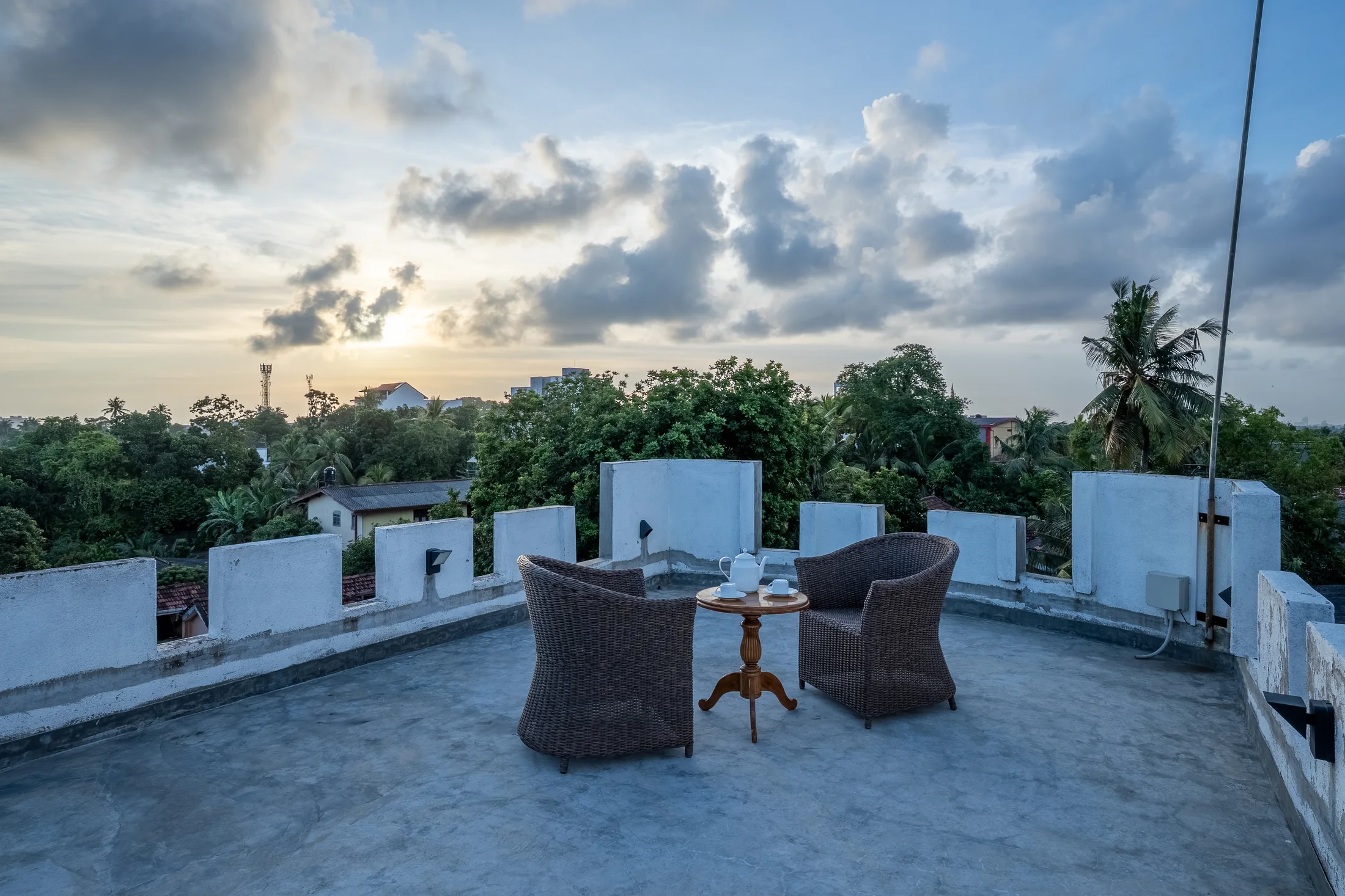 Private rooftop seating overlooking trees and the distant horizon